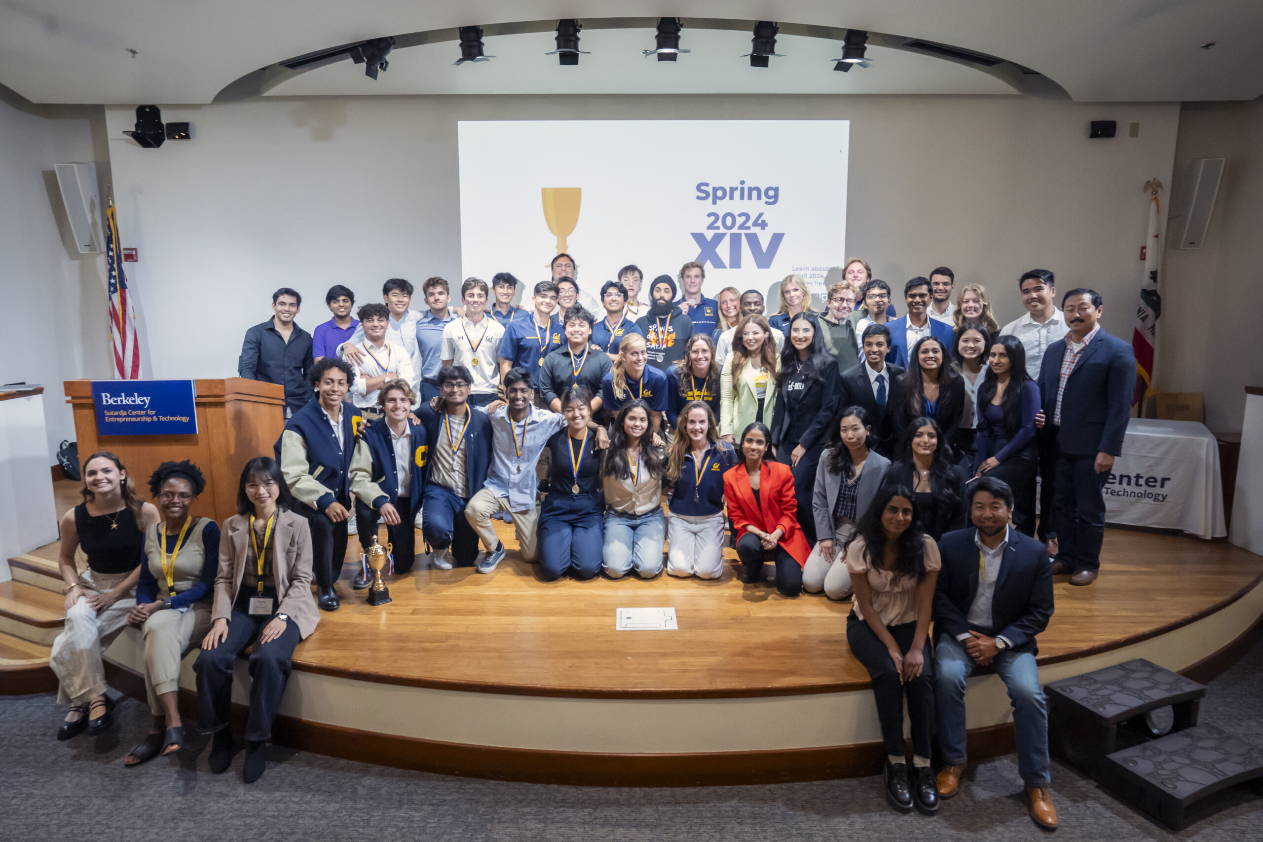 Collider Cup teams, faculty, staff, and judges posing on stage after the Collider Cup event